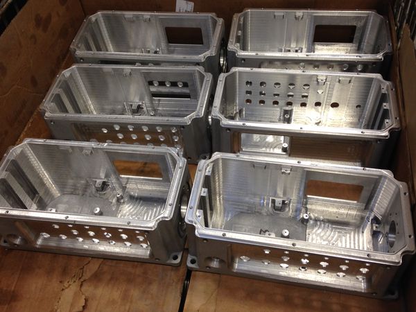 six finished green sand casting components for the telecom industry